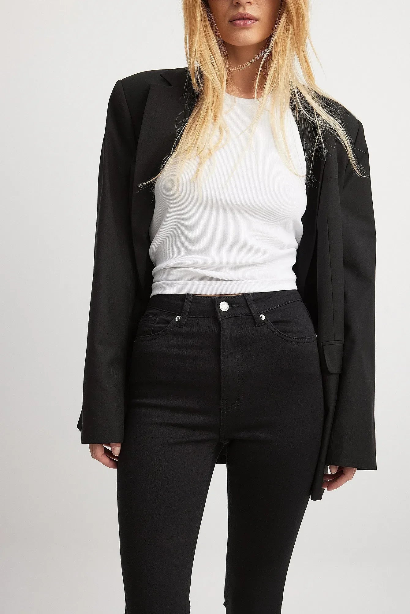 Close-Up of Raw Hem on Skinny High Waist Jeans – Detailed shot of the raw hem and fabric.